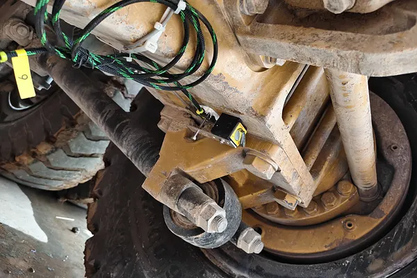 Sensor wiring routed along a hydraulic line