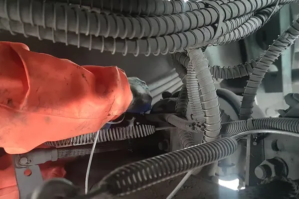 Engineer checking a cable harness on site
